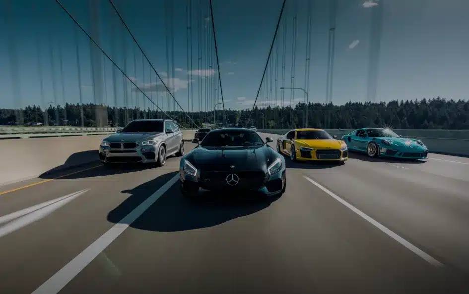 European auto repair in St. Charles, IL by Precision Motorworks. Image of luxury European vehicles including BMW, Mercedes-Benz, Audi, and Porsche driving on a bridge, representing precision service and performance care.