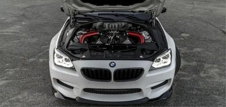 BMW repair in St. Charles by Precision Motorworks. Image of a BMW with hood open, displaying a performance engine upgrade and professional maintenance service.