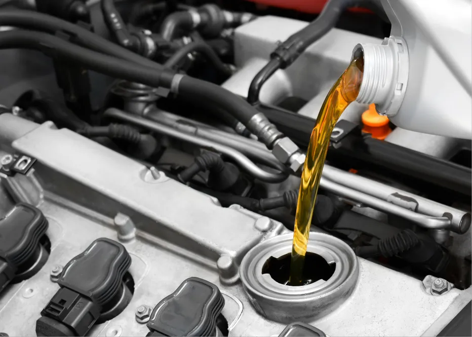 Oil change services in St. Charles, IL by Precision Motorworks. Image of fresh motor oil being poured into an engine, highlighting the shop’s commitment to preventative maintenance, vehicle performance, and long-term engine protection.