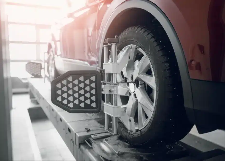 Wheel alignment in St. Charles, IL by Precision Motorworks. Image of a vehicle on an alignment machine with sensors attached to the wheels, showcasing the shop’s dedication to precise alignment, safety, and smooth driving performance.