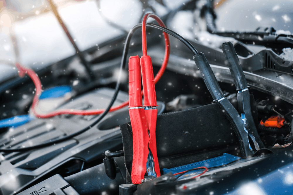 Electrical problems, European auto repair in St. Charles, IL by Precision Motorworks. Image of jumper cables connected under the hood, highlighting cold-weather battery assistance and reliable starting support for drivers.